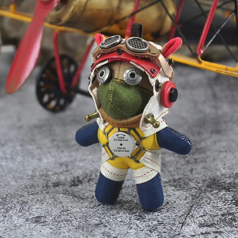 Dark vintage pilot dog with leather flight jacket and round goggles. Gothic artisan art toy, macabre collector keychain.