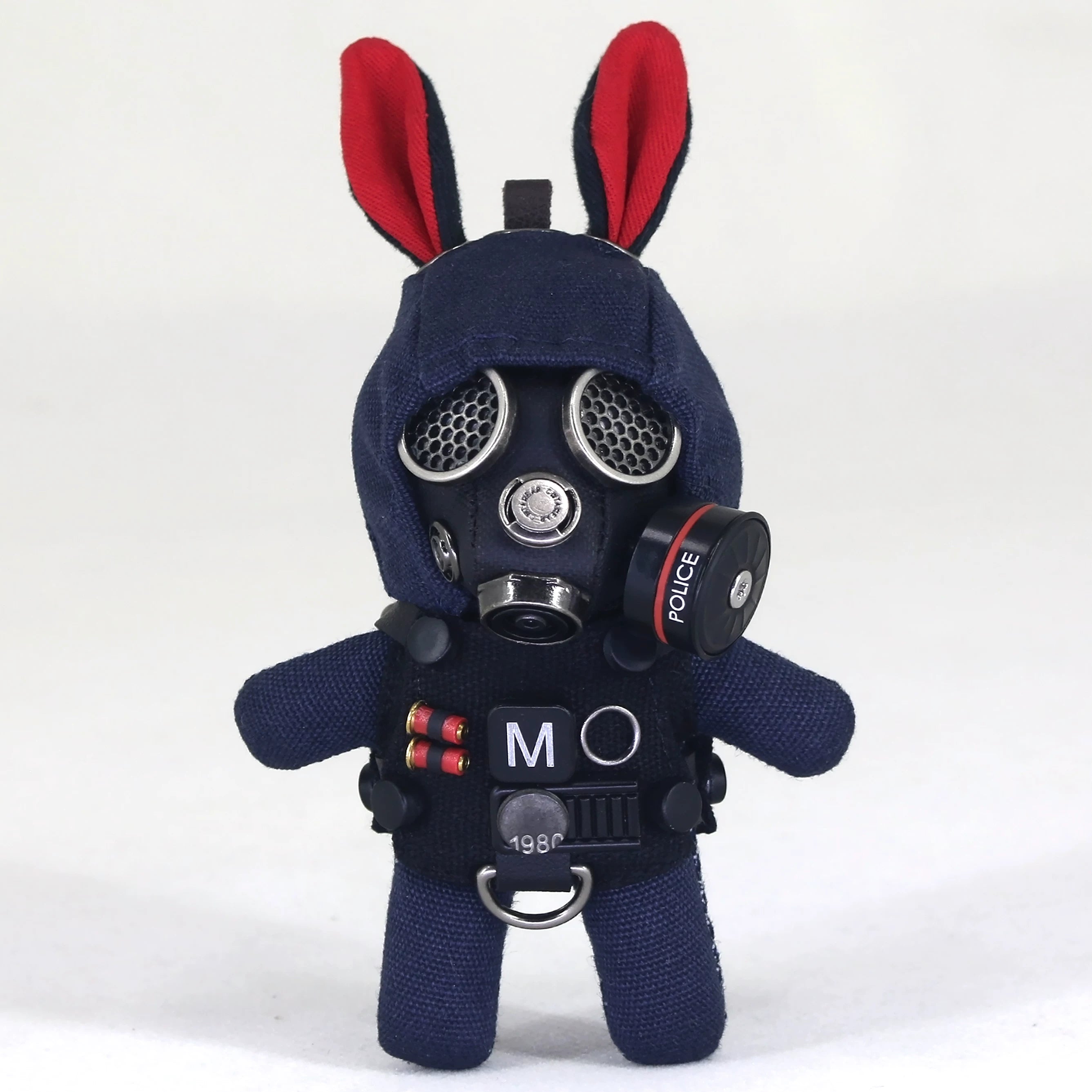 Bunny wearing complex black gas mask with silver filter and dark tactical gear. Gothic artisan macabre art toy, dark collectible.