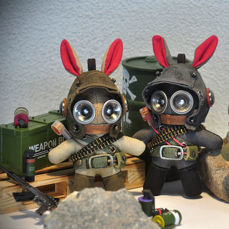 Tac-bunny duo in earth-tone military gear with skull-and-crossbones ammo box. Dark wasteland aesthetic, gothic art toy, post-apocalyptic collectible.