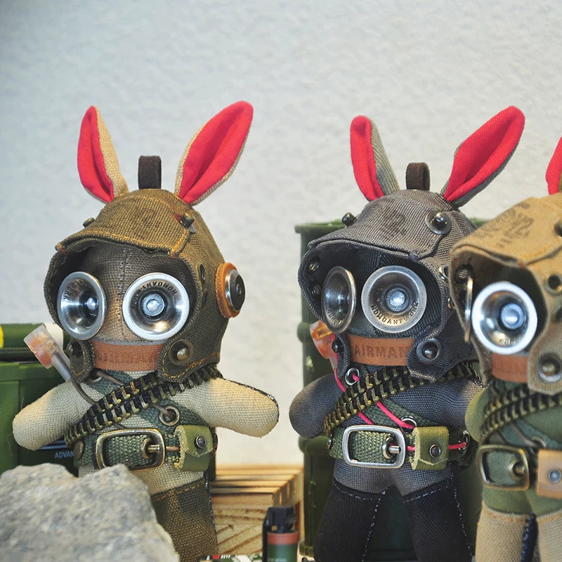 Gothic bunny soldiers wearing tan tactical suits with goggled aviator helmets. Dark military aesthetic, macabre artisan art toy collectible.