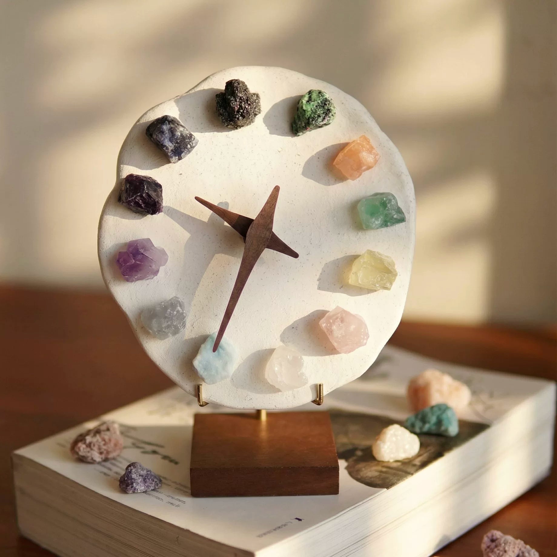 Crystal mineral stone clock featuring 12 raw gemstone hour markers on a clay base with wooden hands. Artisan clock, witchy decor, bohemian home accent.