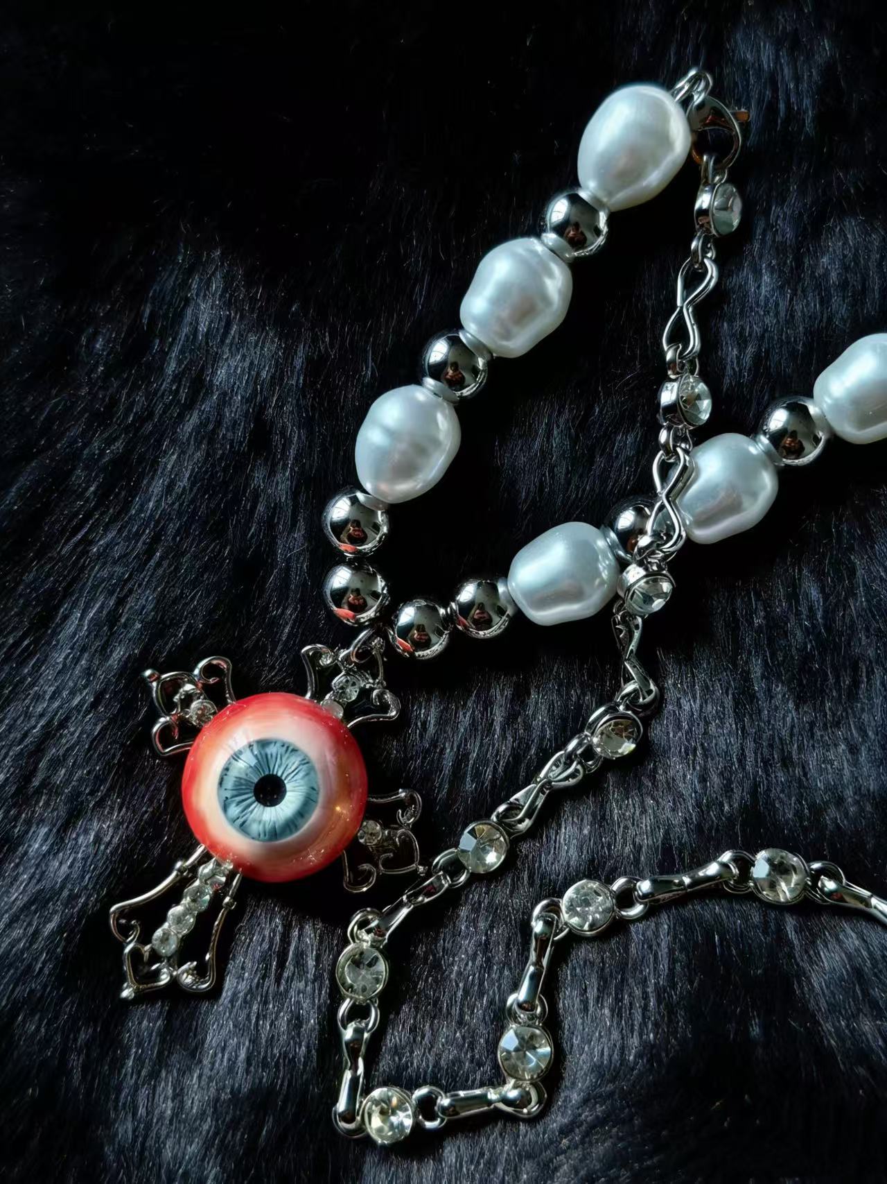 Pray For Dreamers dark art eyeball necklace close-up product photography