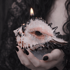 Angled view of conch shell candle holder with sculpted eye and exposed shell ridges