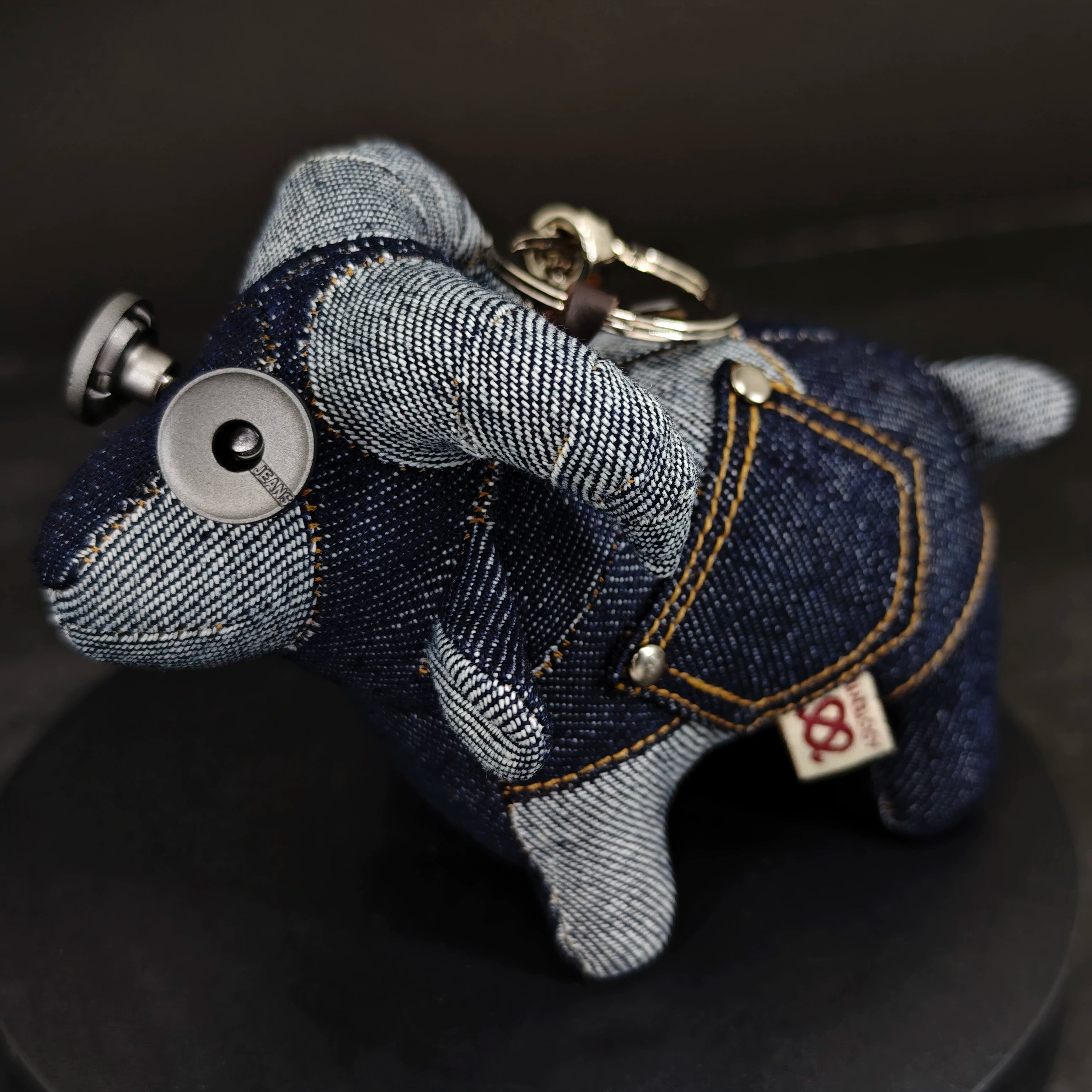 Rustic artisan denim lamb with visible denim twill texture and contrast stitching. Gothic folk art style, macabre collectible.