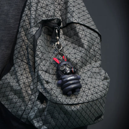 Bunny in black gas mask with chrome valves and mesh eyepieces, dark quilted tactical jacket. Dark macabre artisan art toy collectible.