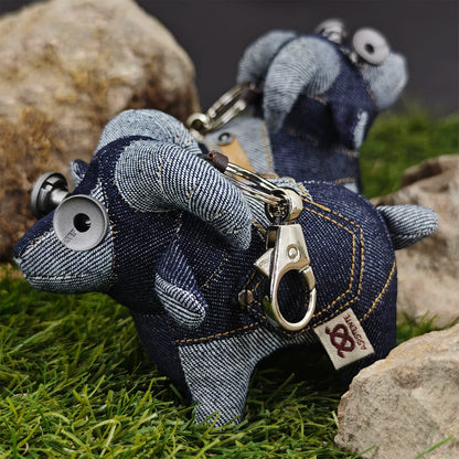 Denim lamb keychain in indigo with lighter blue accents and metal hardware. Dark artisan craft, macabre folk art toy.