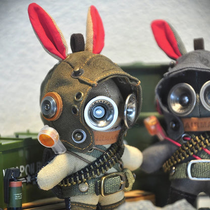 Military bunny with goggled aviator helmet and ammunition bandolier. Dark post-apocalyptic aesthetic, gothic artisan art toy collectible.