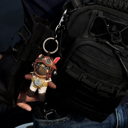 Aviator Pilot Dog Coffee Version — Mini Plush Keychain — detail close-up of leather collar strap, TURN TO UNLOCK / PRESS TO RELEASE chest disc buckle, handcrafted fabric texture — Awhisker