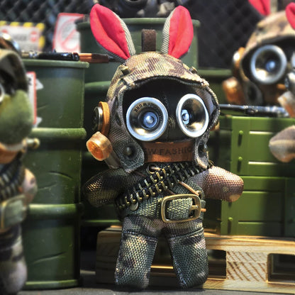 Gothic military bunny wearing camo tactical suit and goggled aviator helmet. Dark artisan macabre art toy, post-apocalyptic collectible.