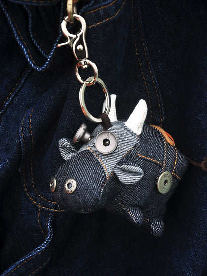 Gothic artisan ox in deep blue-gray fabric with visible stitching details. Dark macabre folk art, artisan collectible keychain.