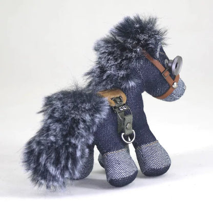 Denim horse collectible featuring a worn leather halter with D-ring hardware and voluminous gray fur mane. Dark artisan craft piece, macabre decor.