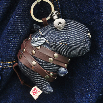 Denim hippo figurine in deep indigo with blue-gray fabric and orange contrast stitching. Dark folk art artisan keychain, macabre collectible.