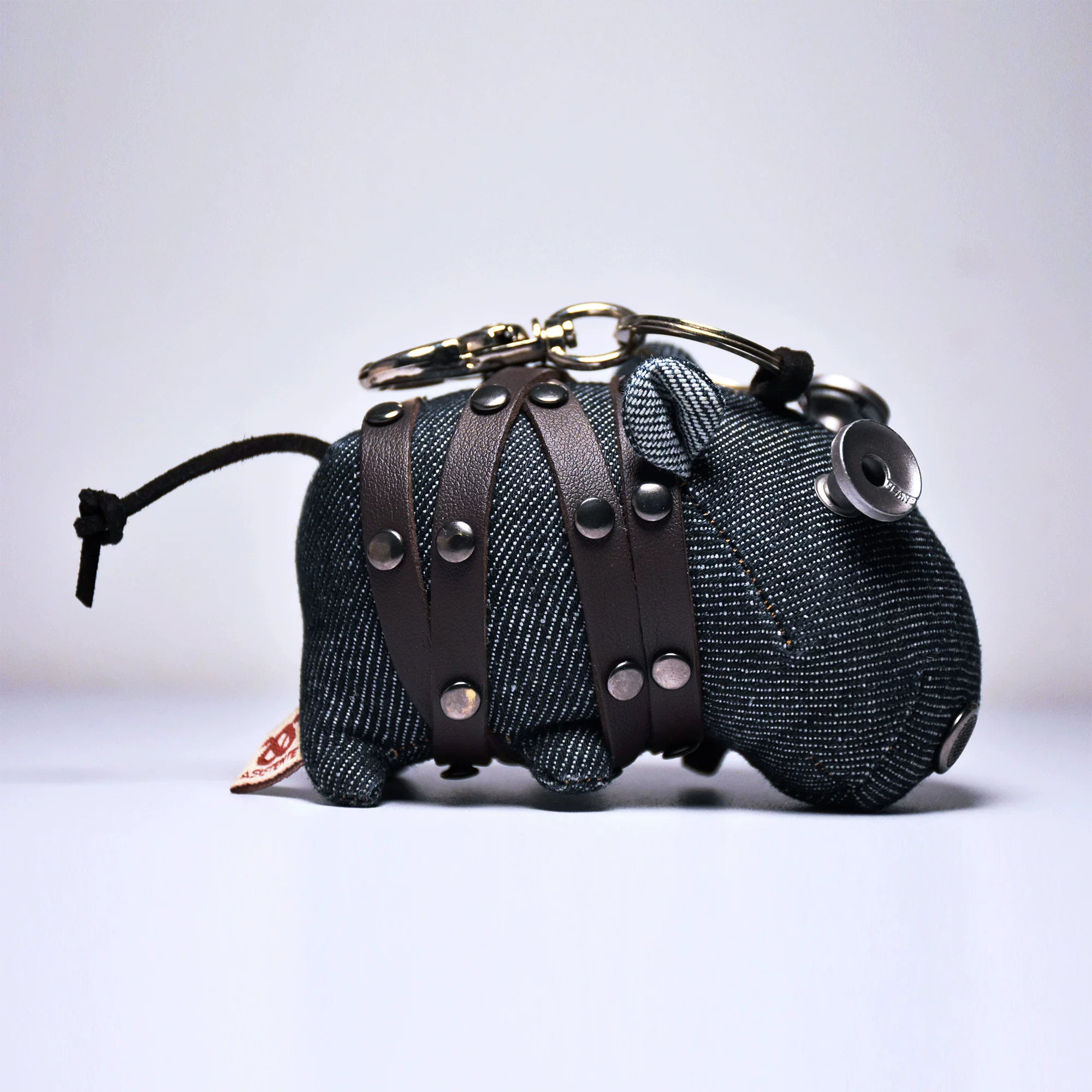 Indigo denim hippo with rounded form and blue-gray tones. Gothic rustic artisan craft, dark folk art collectible.