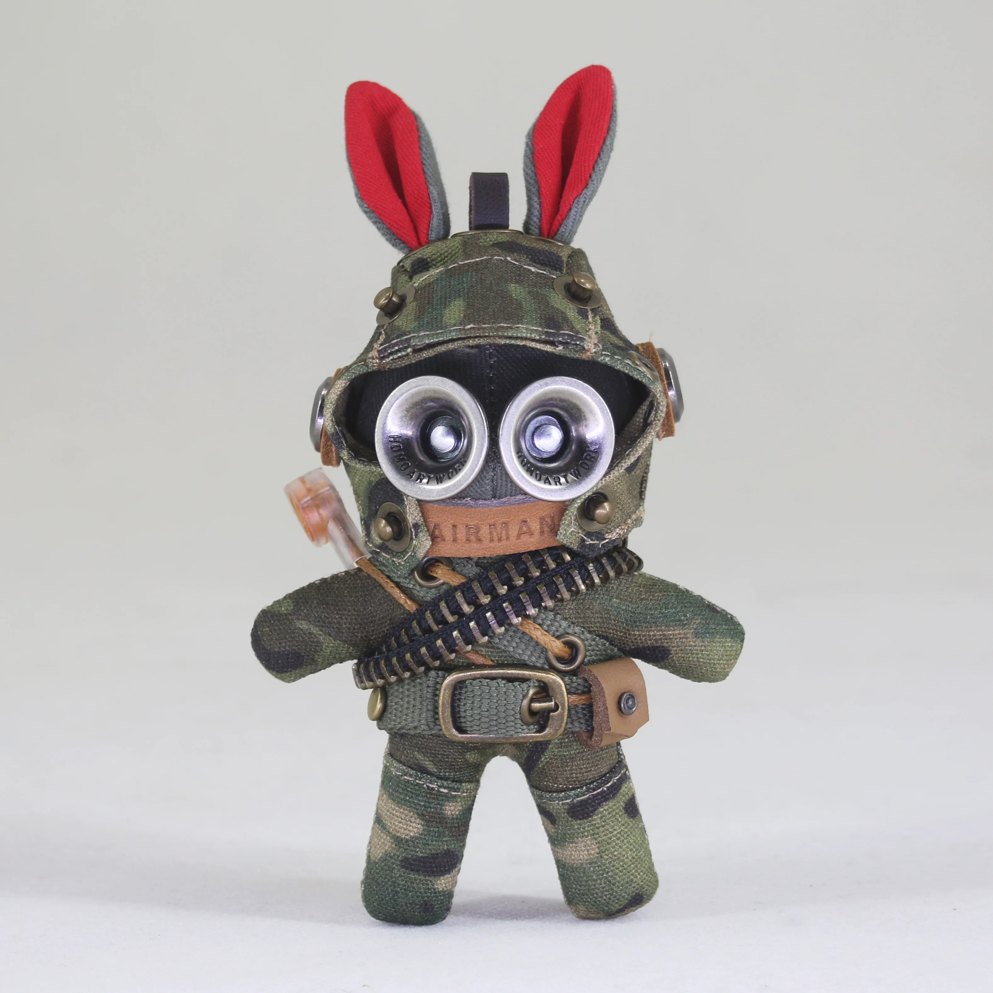 Tactical bunny soldier in dark camo with ammo bandolier and utility belt. Gothic artisan art toy, dark macabre designer keychain.