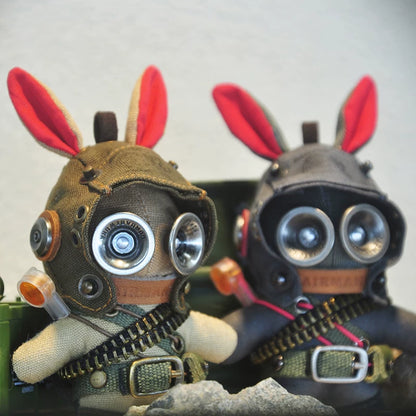 Tac-bunny soldier wearing black tactical suit and armored helmet. Dark military aesthetic, gothic artisan art toy, macabre collectible.