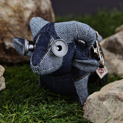 Denim lamb plush showing blue-gray curly fleece texture and orange stitching. Gothic rustic artisan craft, dark folk art collectible.