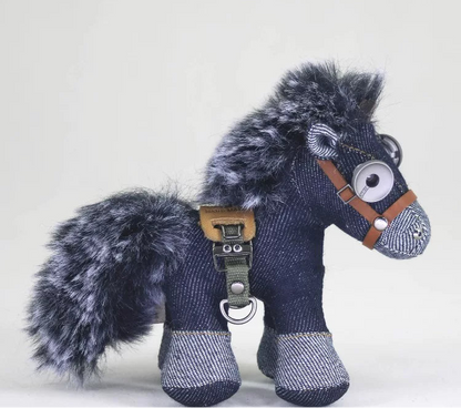 Blue denim horse figure with hand-stitched seams and distressed metal button eyes. Gothic rustic art toy, macabre folk aesthetic.