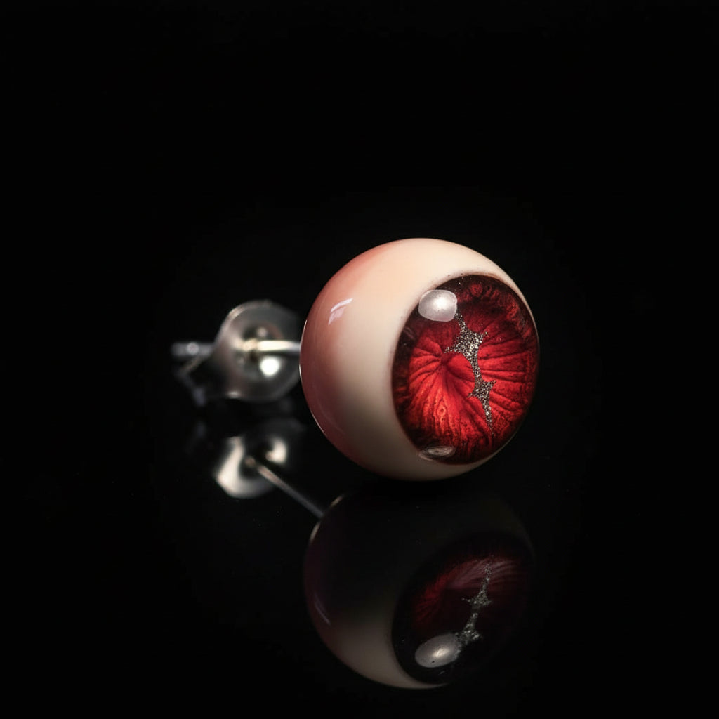 Side view of single crimson magma eyeball stud on reflective black background