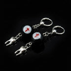 Gothic crimson cross faux eyeball tooth charm drop earrings on solid black background
