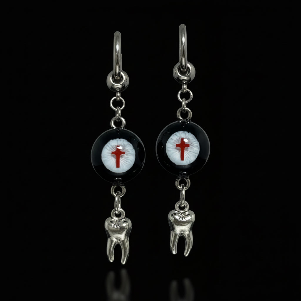 Pair of gothic crimson cross faux eyeball tooth charm drop earrings on solid black background