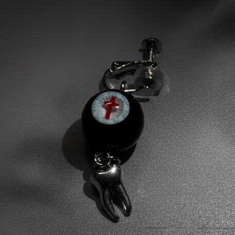 Single gothic crimson cross faux eyeball tooth charm drop earring on grey background