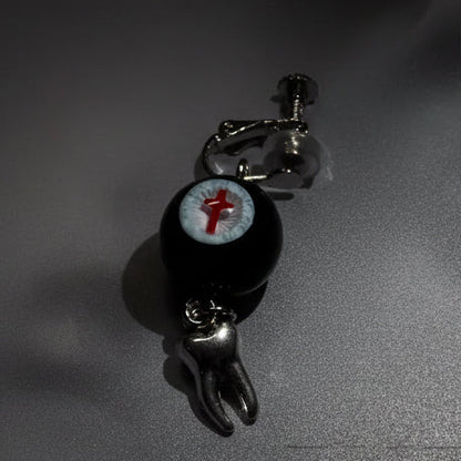 Single gothic crimson cross faux eyeball tooth charm drop earring on grey background