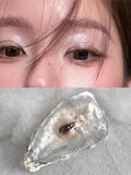 Lovers eye pendant, pale pink sculpted eye, blue iris, baroque pearl drop chains, on black glass plate, dark background