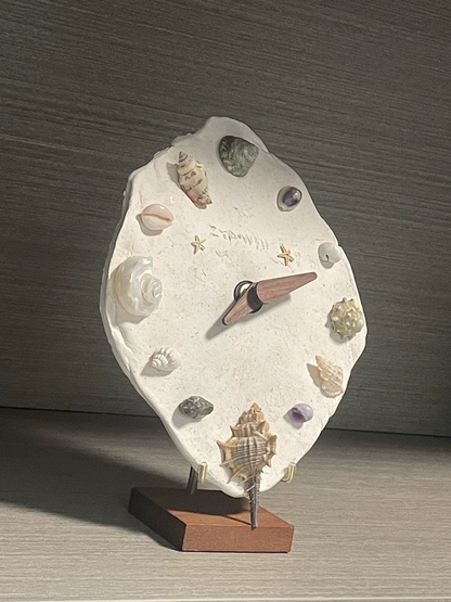 Seashell and crystal clock DIY kit in dark oceanic aesthetic. Gothic artisan craft materials, macabre home decor assembly.