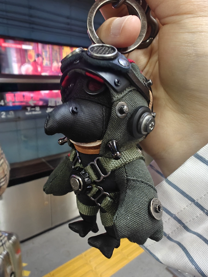 Handmade Bird Pilot Dark Version side angle — miniature Q-mode plush toy, gothic collectible charm, backpack accessory — Awhisker