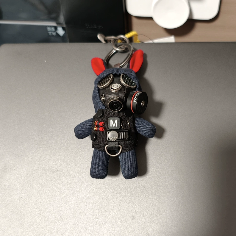 Gothic bunny in black gas mask featuring detailed chrome valves and mesh eyepieces. Dark artisan macabre art toy collectible.