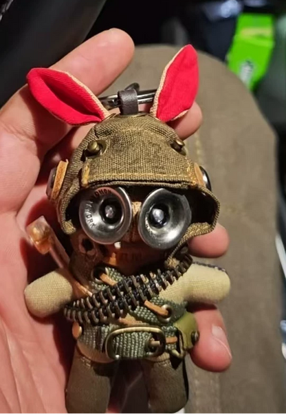 Pair of dark tactical bunny figures with red bunny ears from armored helmets. Gothic military art toy, post-apocalyptic collectible.