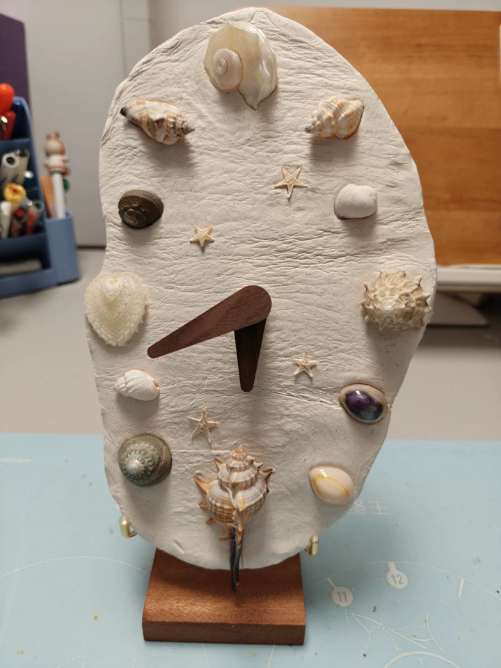 Seashell clock artisan kit featuring natural textures and gothic crystal accents. Dark macabre home decor materials, craft collectible.