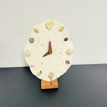 Gothic seashell clock with natural shell texture and mineral crystal accents. Dark artisan home decor, macabre craft materials kit.
