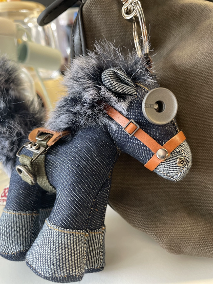 Rustic artisan denim horse figurine with gray fur mane and aged metal hardware. Dark folk art style, gothic craft keychain.