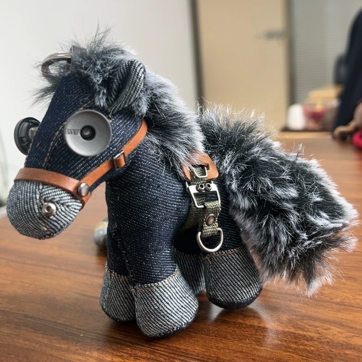 Artisan denim horse figure with metal hardware accents and rustic stitching detail. Dark folk art style, gothic craft collectible.