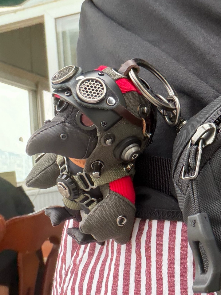 Handmade Bird Pilot Dark Version detail — red accent eyes and handcrafted fabric texture, artisan collectible toy — Awhisker